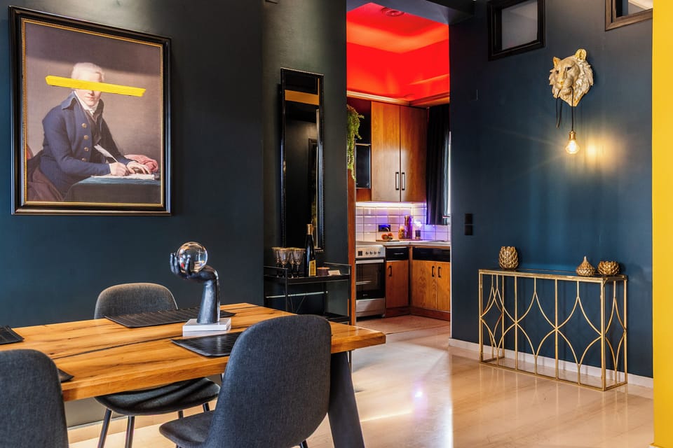 Elegant dining area with a long natural wood table, lush plants
