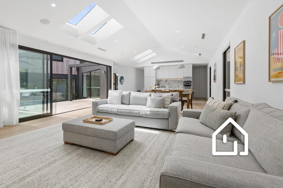 Open plan living; downstairs living and kitchen which opens to outdoor pool deck