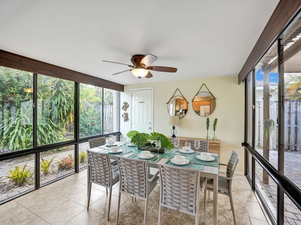 Dining area surrounded by sunlight and views of the garden