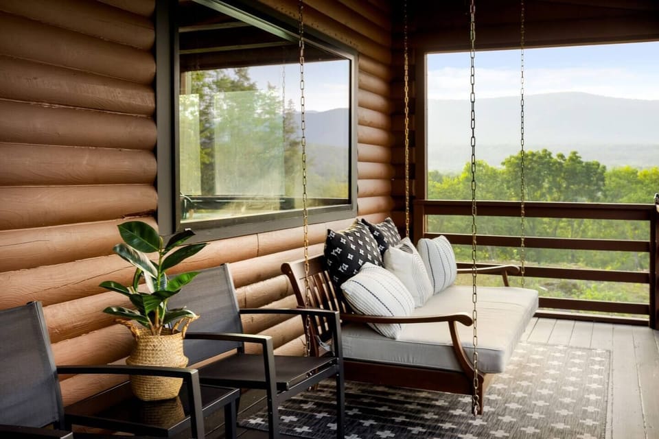Nature's Embrace: Enjoy the beauty of the outdoors from our screened-in porch with a swing the ideal spot to sip your morning coffee or stargaze at night. 