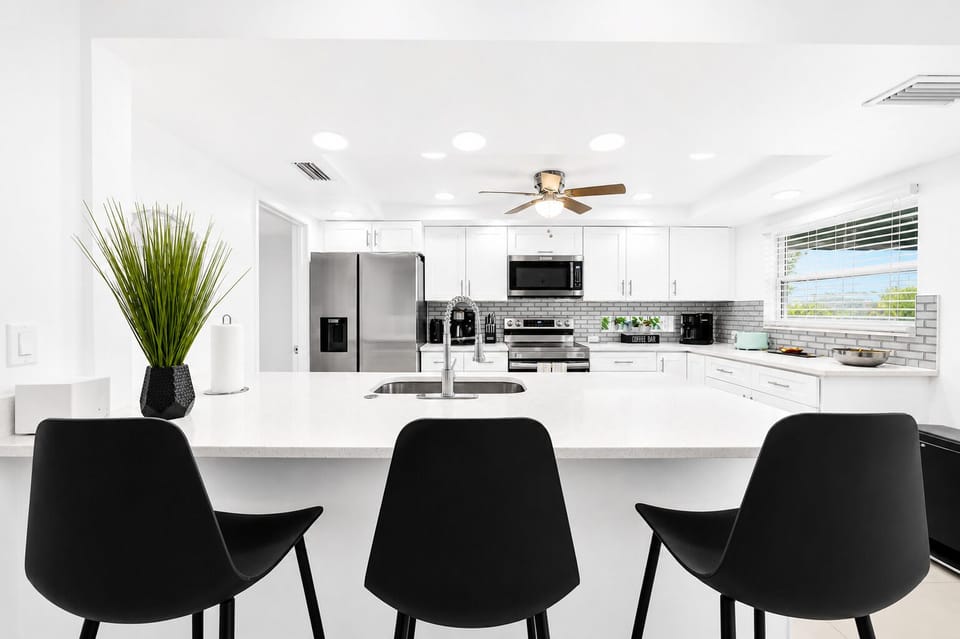 Large kitchen island with bar seating, perfect for gathering, dining, and entertaining.