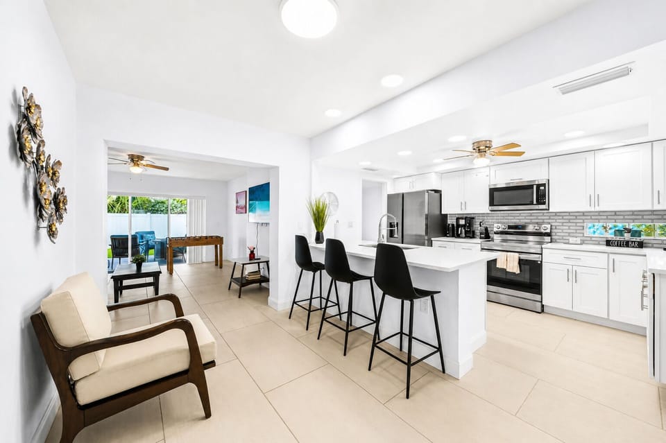 Open kitchen and living area with spacious seating, bright lighting, and inviting atmosphere.