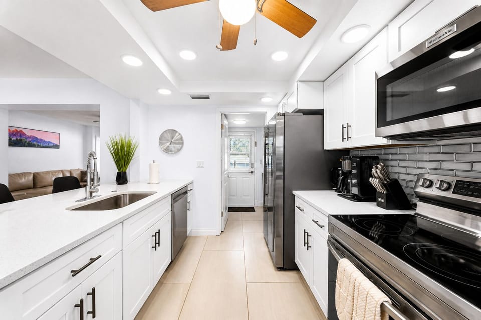 Sleek modern kitchen featuring stainless steel appliances, spacious countertops, and bright open layout.