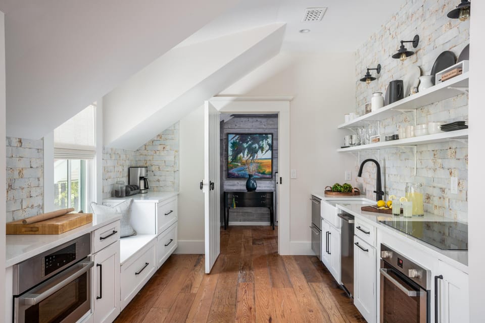 Full kitchen with oven, cooktop, dishwasher, and microwave.