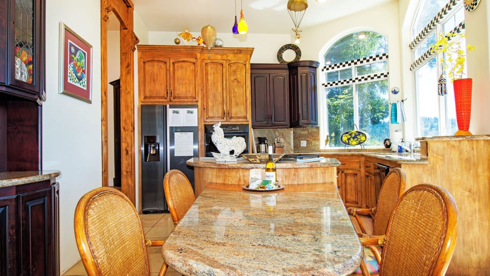Kitchen with gas stove top, electric oven, dishwasher & refrigerator with ice. 