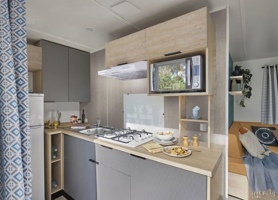 Compact yet fully equipped kitchenette, ideal for preparing meals in a cozy setting.