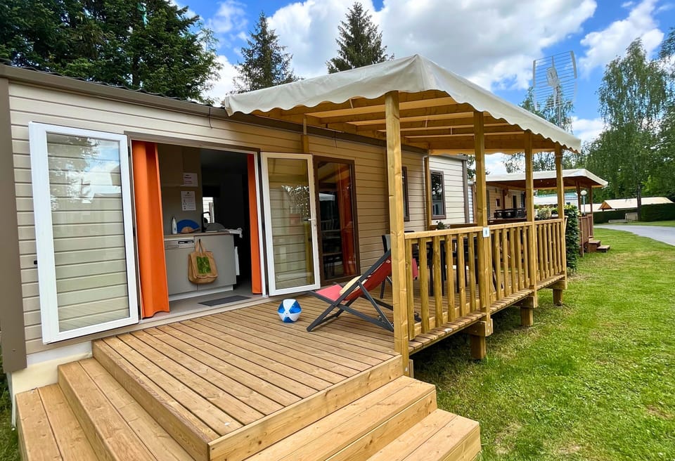  Embrace the outdoors on this spacious wooden deck, the perfect spot to unwind with a cup of coffee or enjoy a quiet afternoon surrounded by nature.