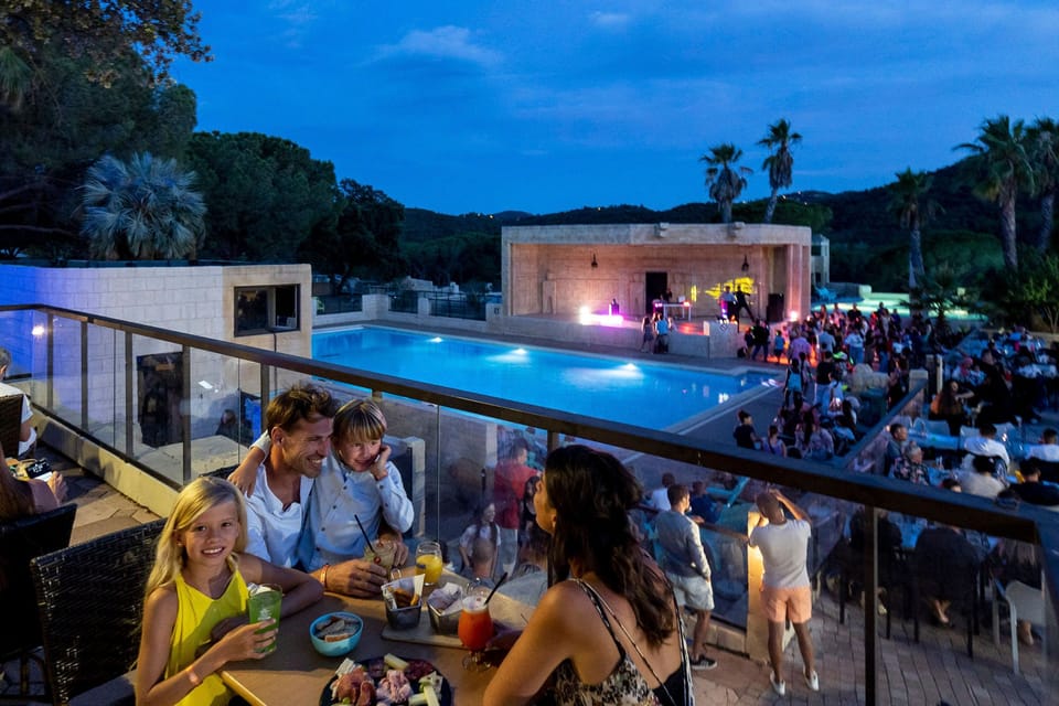 Savor delightful moments with loved ones over drinks, with the night lights dancing by the pool.
