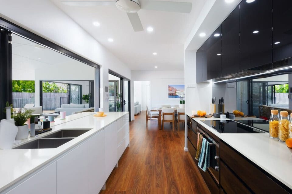 Bosch induction stovetop and oven, inbuilt dishwasher and rubbish bins and a hidden pantry all for a seamless experience