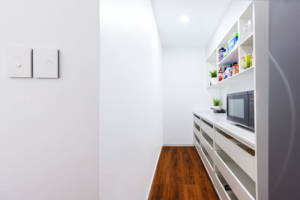 Hidden pantry, stocked with extras, essentials, tea, sugar, coffee, hand towels, microwave and storage boxes to prepare for any situation
