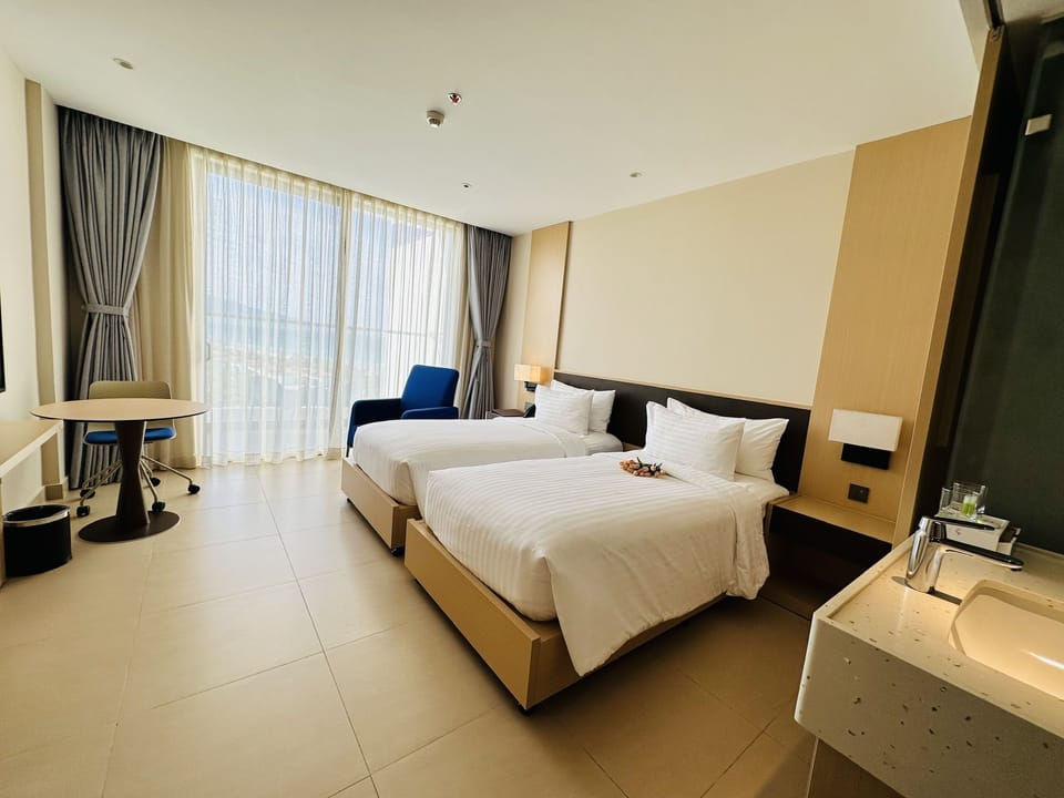 Deluxe Twin Room, Partial Sea View | In-room safe, blackout drapes, iron/ironing board, WiFi (free)