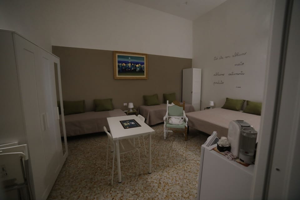 Family Quadruple Room, Courtyard View | In-room safe, individually furnished, desk, blackout drapes