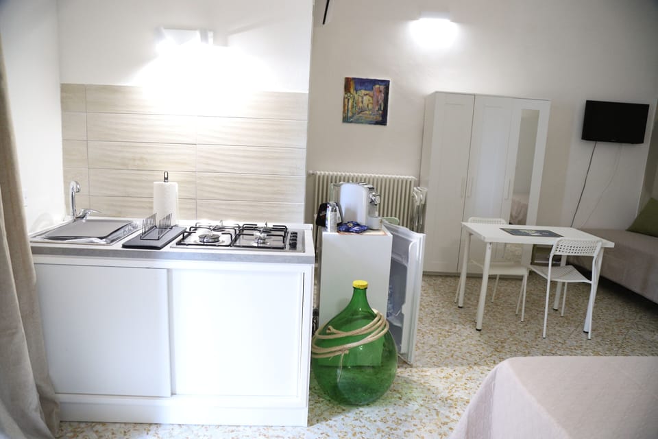 Family Quadruple Room, Courtyard View | Private kitchen | Full-size fridge, stovetop, espresso maker, coffee/tea maker