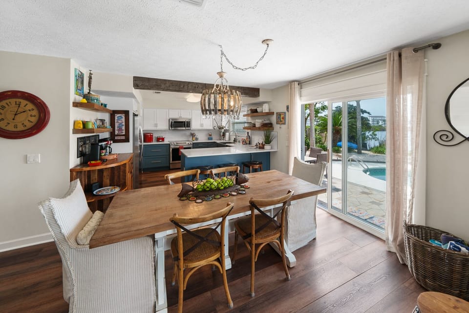 Gather around your spacious dining table where warm wood tones and charming coastal decor create the perfect spot for memorable meals together.