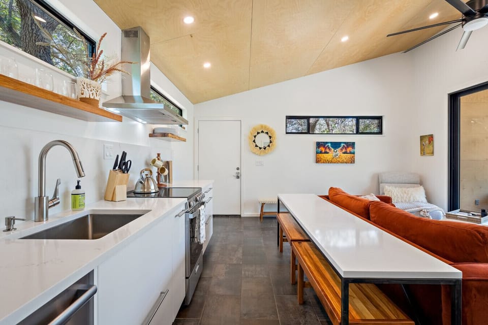Sleek, open kitchen and dining area designed for easy cooking and connection