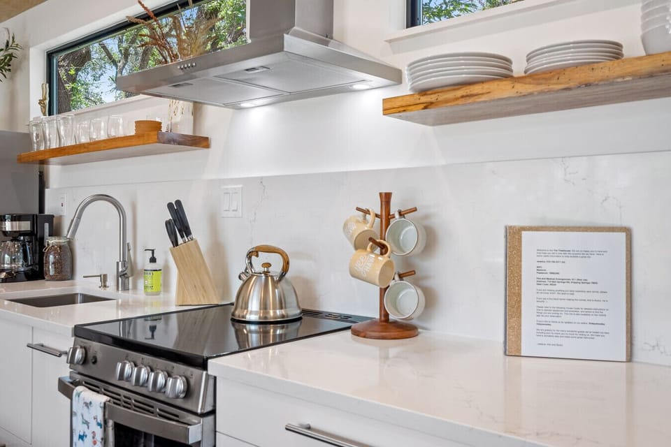 Modern, fully stocked kitchen with open shelving and thoughtful design details