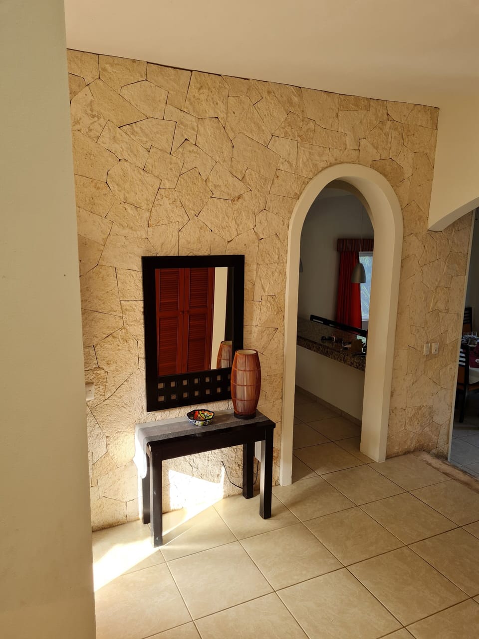 View from stairs of front hallway and kitchen entrance
