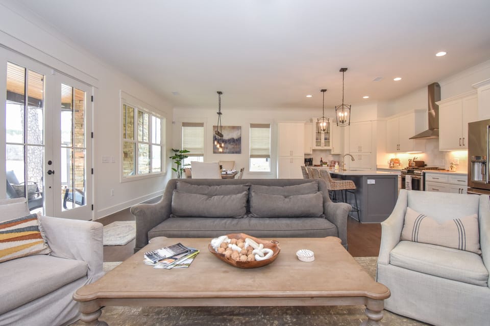 Living area includes sofa and 4 swivel chairs to view the lake