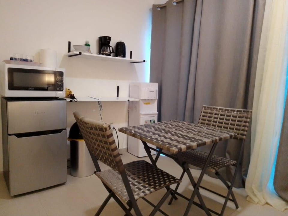 Chairs and table for morning coffee in master bedroom with street view.