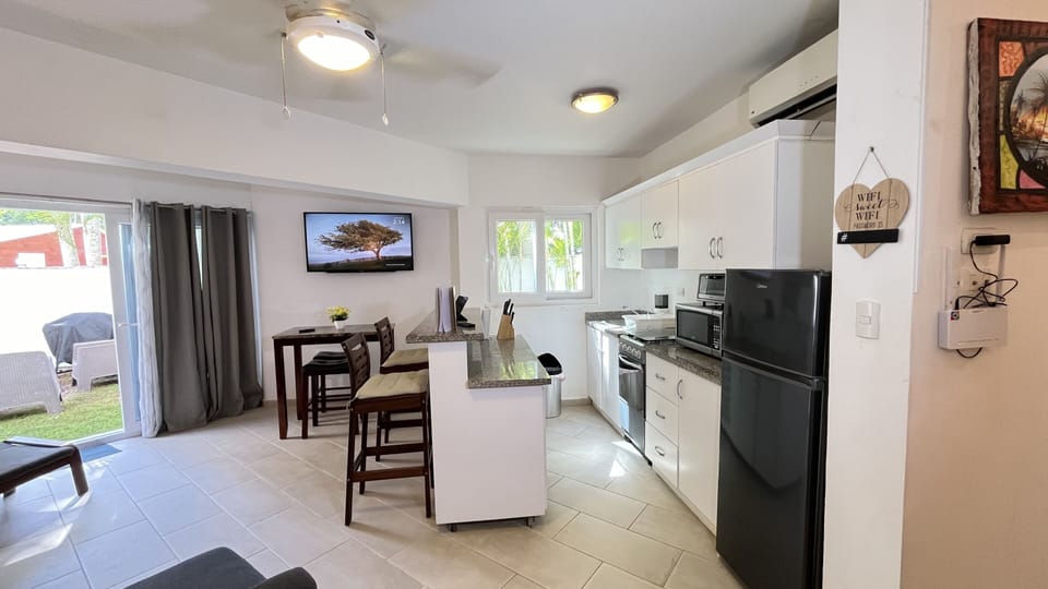 Full kitchen with bar, stools and working desk etc.