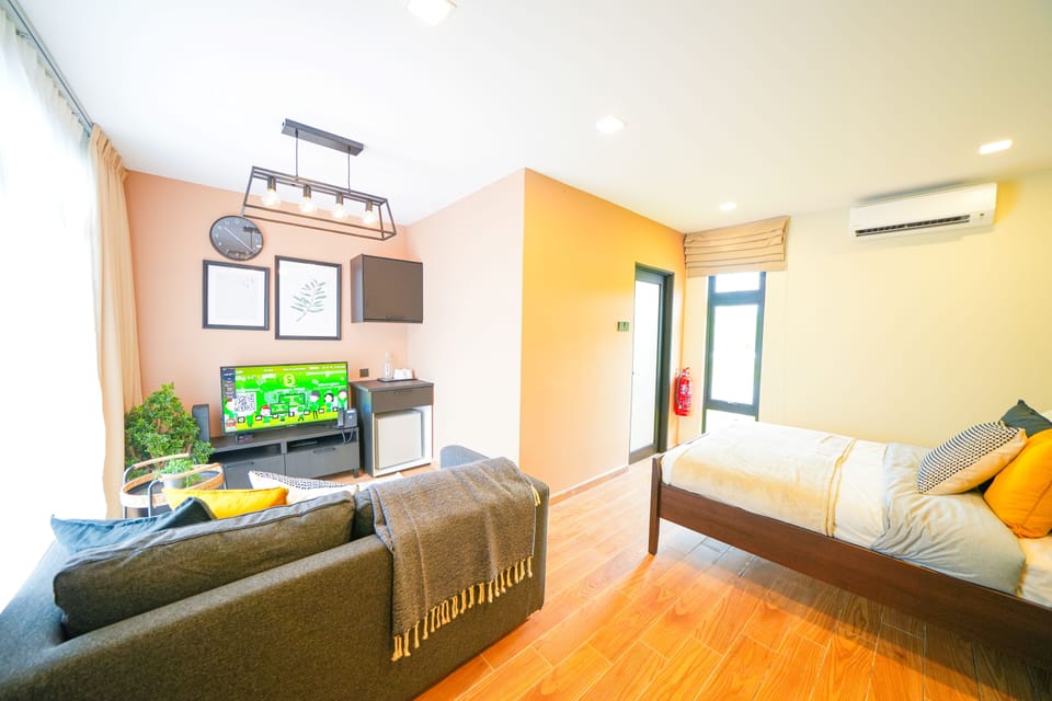 Premium Studio Suite | Living area | 45-inch Smart TV with digital channels, smart speakers