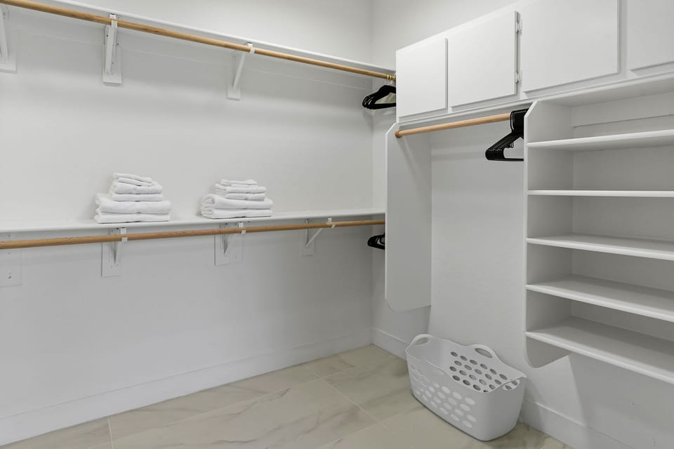 Primary ensuite standing tub, walk-in shower, walk-in closet, and private toilet