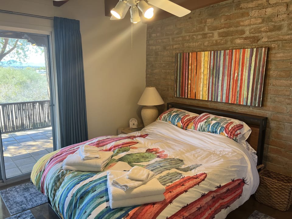 Queen-size Purple bed, sliding door to front patio.