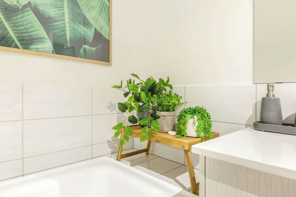 CENTRAL BATHROOM: Sink into the deep bathtub and unwind in a space thoughtfully designed with spa-like touches for a calming and rejuvenating experience.