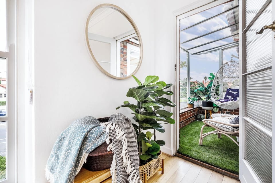 COMMON SPACE: A peaceful corner with natural light, indoor greenery, and access to the outdoor sitting area