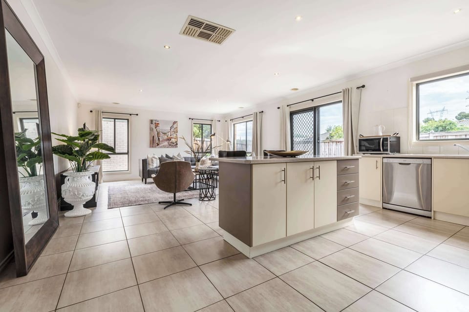 KITCHEN: Spacious kitchen with central island, stainless steel appliances, and plenty of natural light