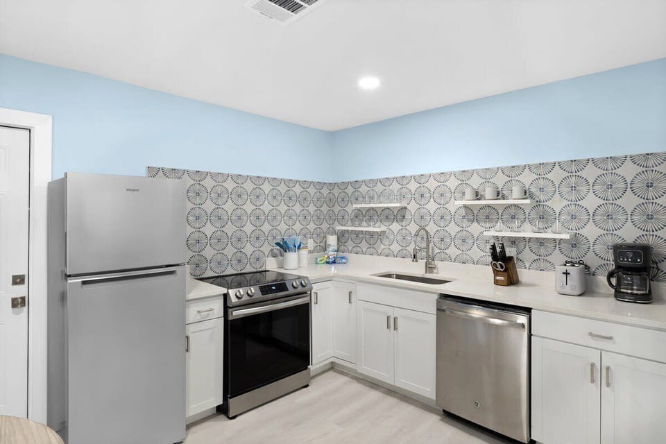 Fully stocked kitchen with brand new appliances and cute dining table overlooking front driveway
