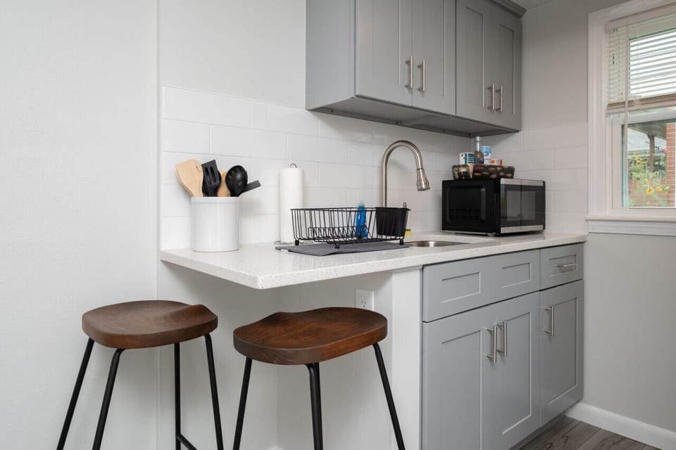 Small space, big convenience! Our modern kitchenette is fully equipped with a microwave, mini-fridge, and all the essential cookware for a quick and easy meal.