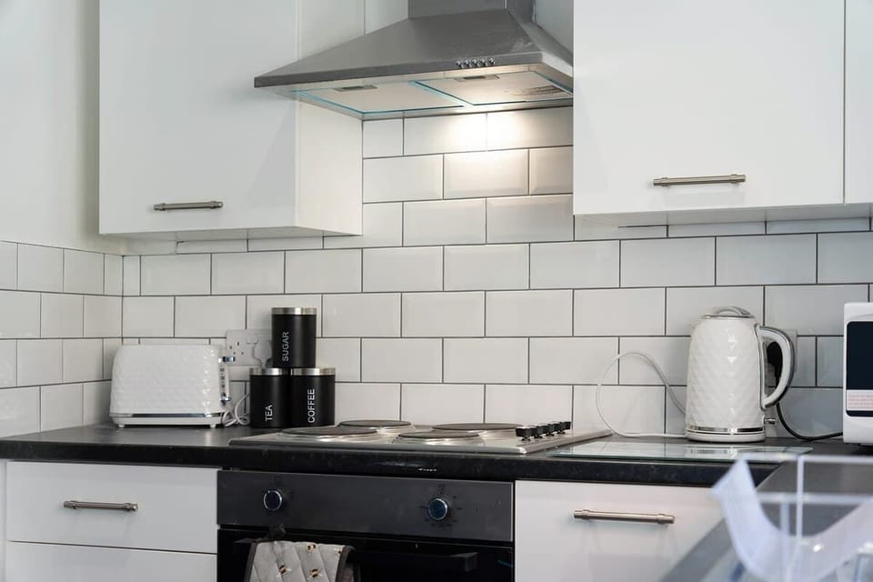 Kitchen equipped with all essentials, including a washer & dryer, oven, fridge and full cookware set.