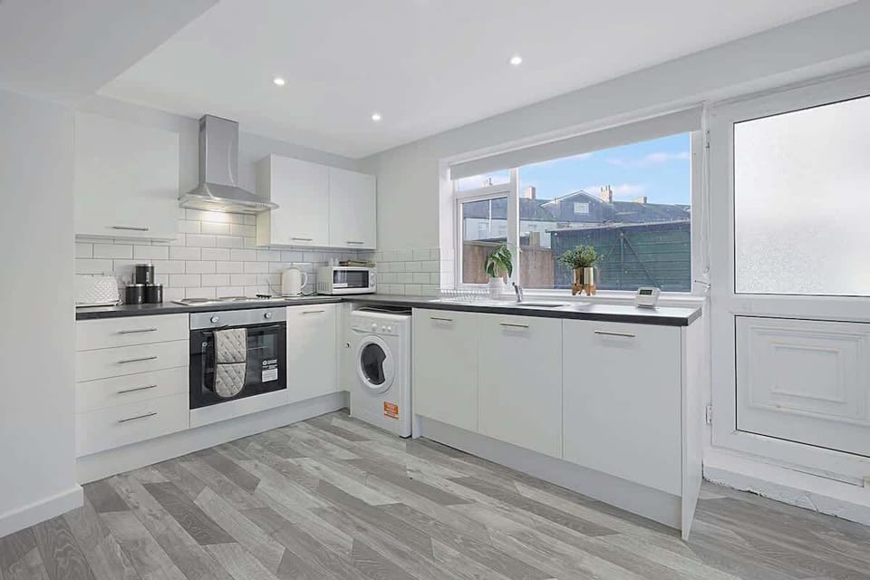Kitchen equipped with all essentials, including a washer & dryer, oven, fridge and full cookware set.