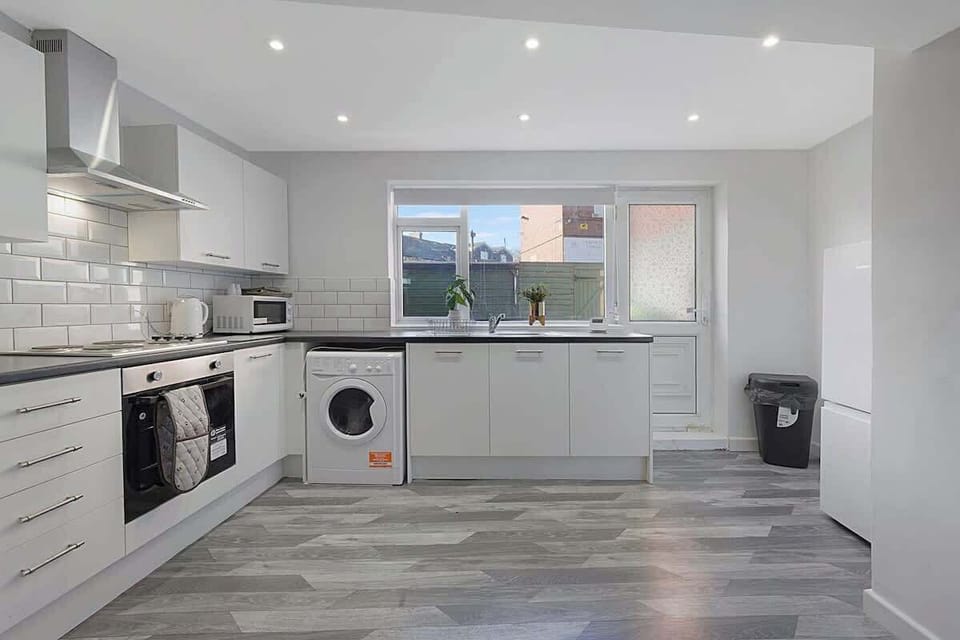 Kitchen equipped with all essentials, including a washer & dryer, oven, fridge and full cookware set.