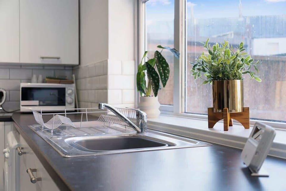 Kitchen equipped with all essentials, including a washer & dryer, oven, fridge and full cookware set.