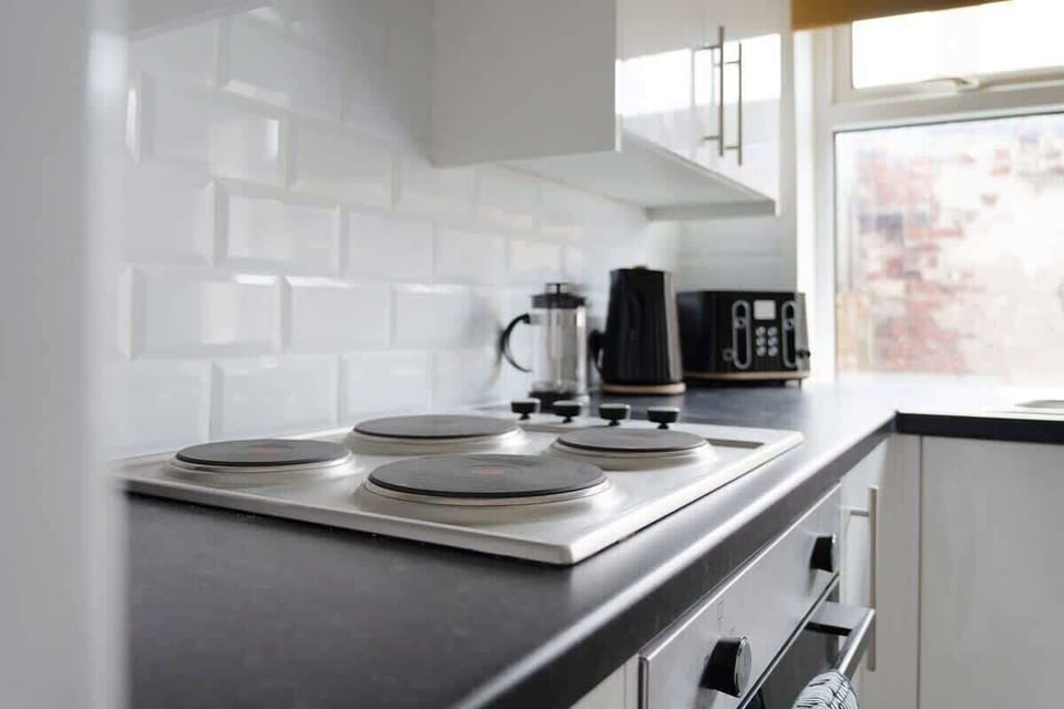 Family-friendly kitchen oasis equipped with all essentials, including a washer & dryer, oven, fridge and full cookware set. 