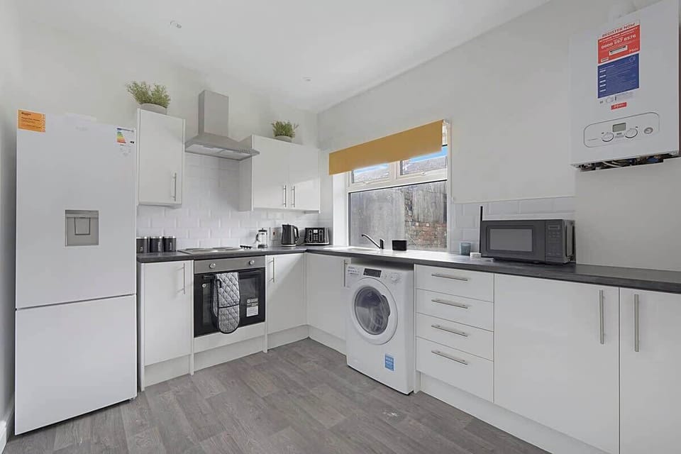 Family-friendly kitchen oasis equipped with all essentials, including a washer & dryer, oven, fridge and full cookware set. 