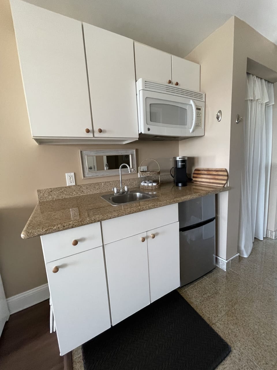 Kitchenette with a hot plate, toaster oven, toaster, freezer, microwave & kuerig