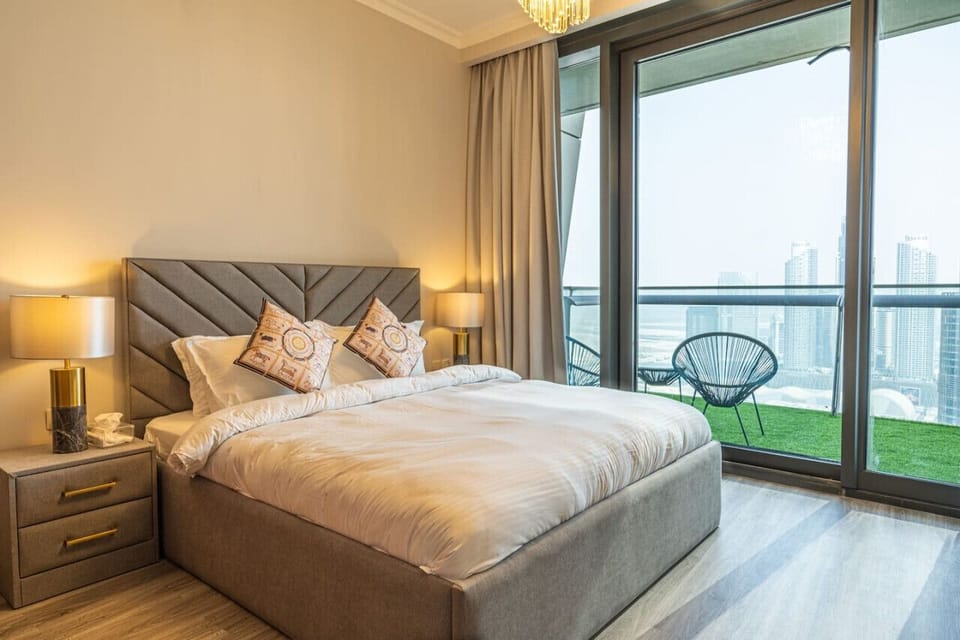 Chic Bedroom: Enjoy stunning skyline views from your stylish retreat with plush comforts!