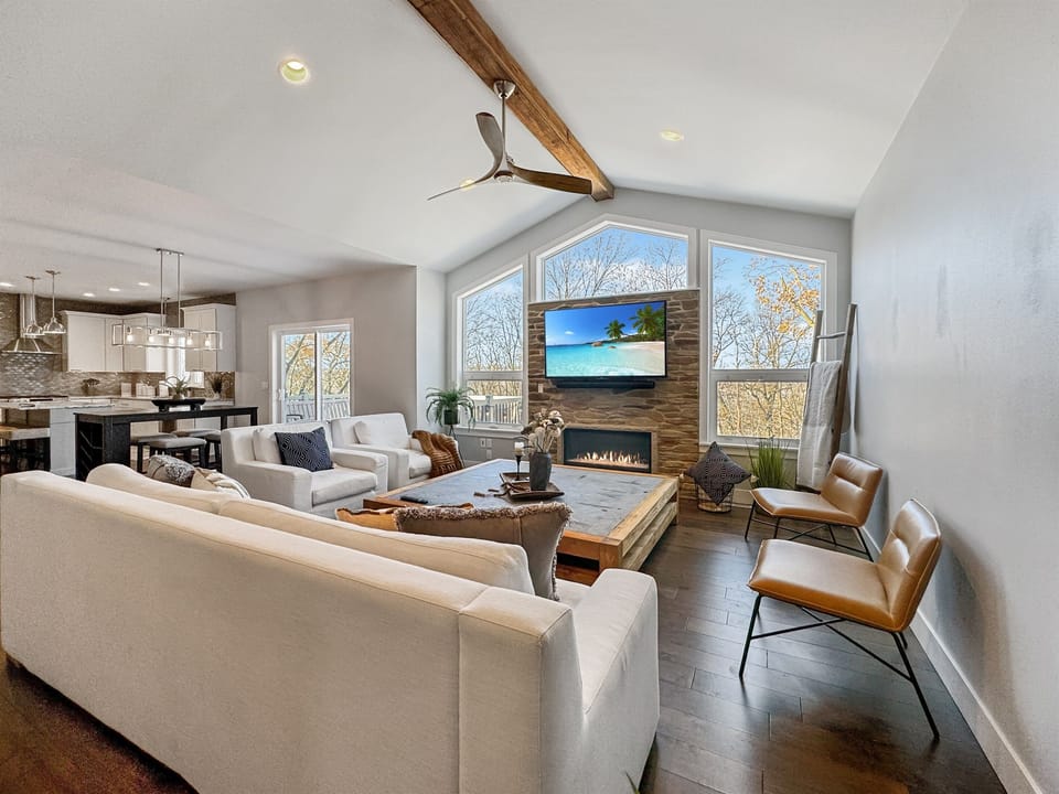 Living room on main complete with smart TV, gas fireplace and ample seating.