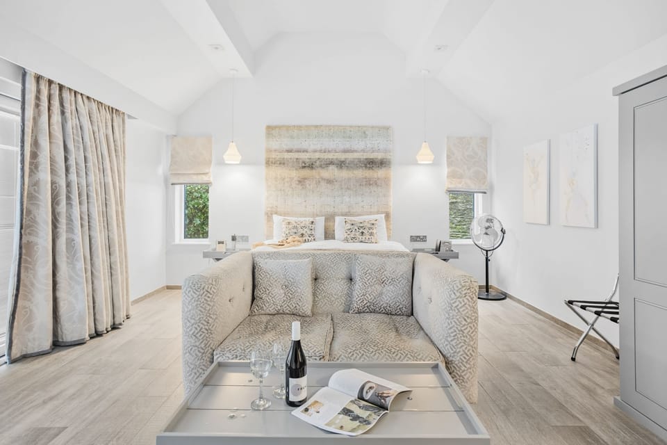 Interior view with seating and bed visible - Cottage Suite 5, Kentisbury Grange