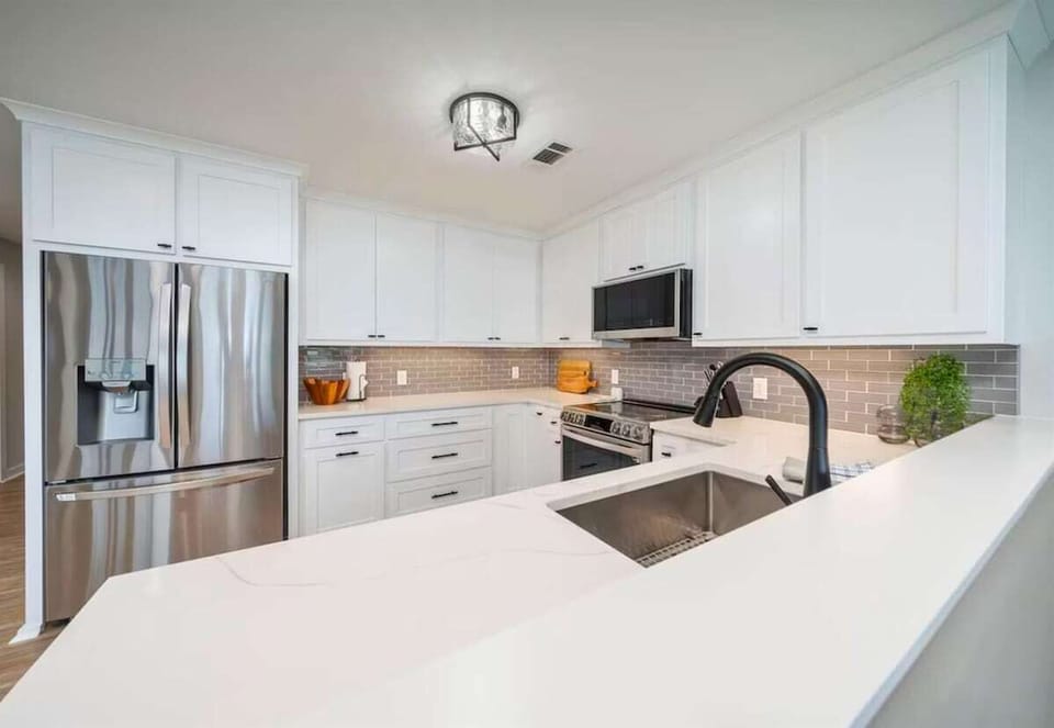 The kitchen features ample counter space and storage, ideal for preparing delicious meals and keeping everything organized.