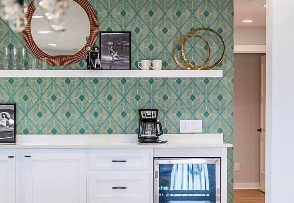 The unique green patterned wallpaper adds a fun and vibrant touch to this space.