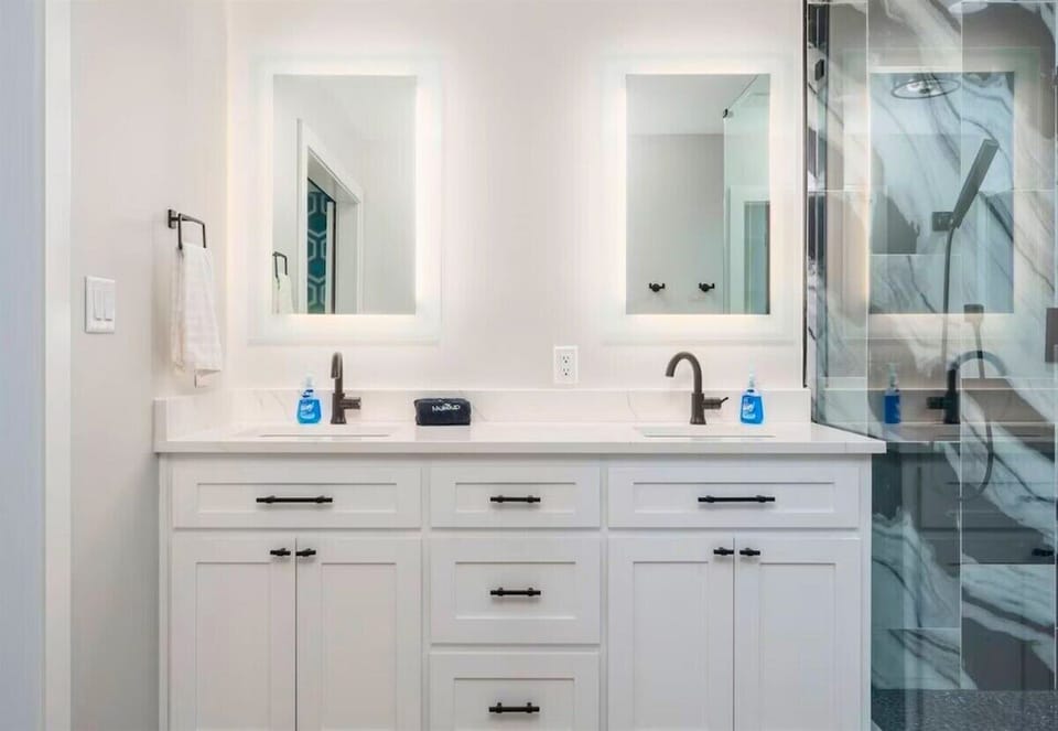 Dual sinks and a large mirror make this bathroom both functional and stylish.