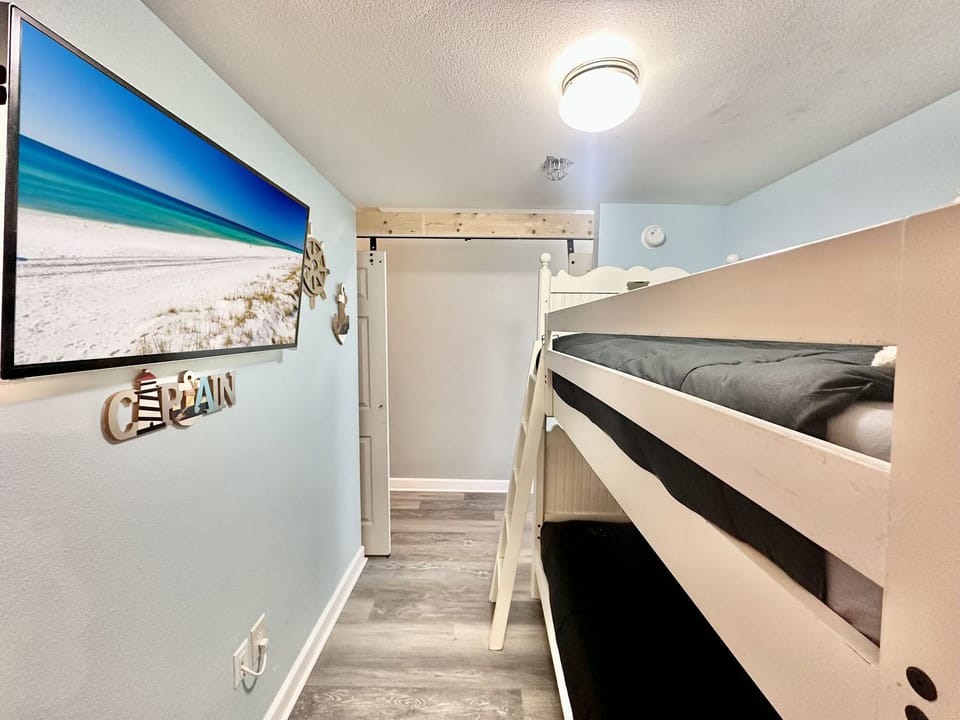 Hallway Bunk Room- Barn Doors with Private TV • Kids’ Space or Extra Guests • Easy Access to Full Bath