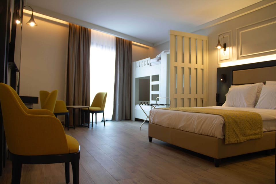Family Room, Multiple Beds | Minibar, laptop workspace, free WiFi, bed sheets