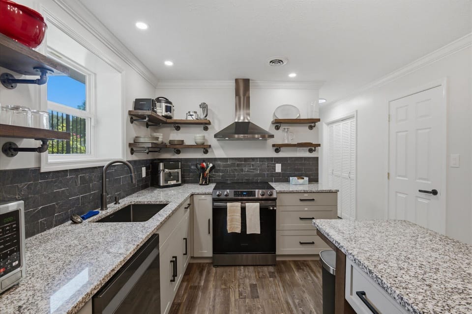 Bright modern kitchen with granite counters and stainless appliances