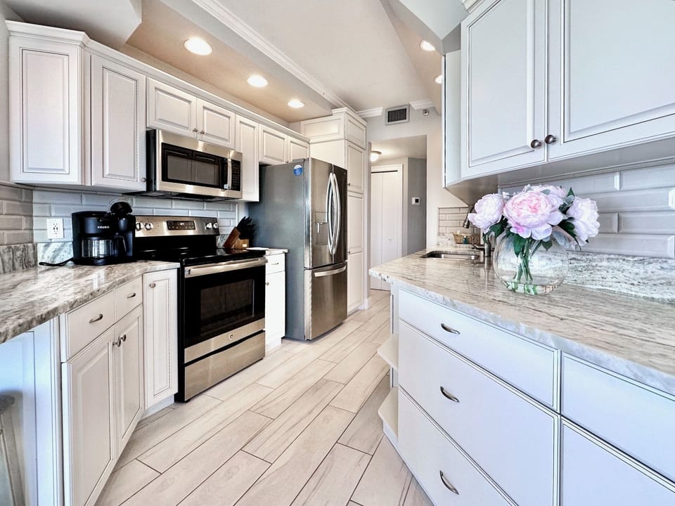 Stainless steel appliance and cabinets galore.