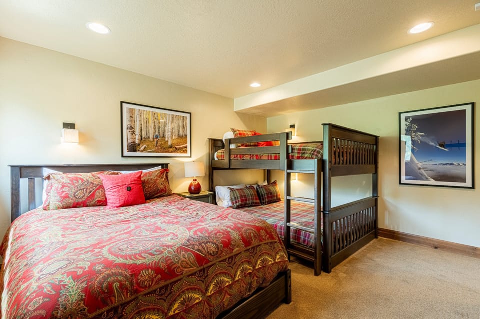 1st level Bedroom 4 with a queen bed and queen over queen bunk beds and private bath